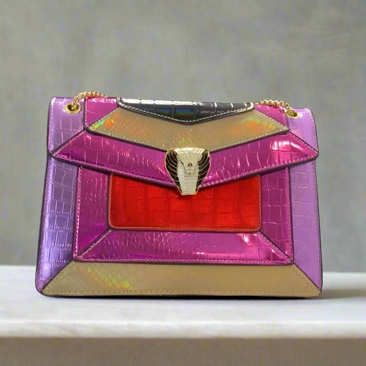 Purple Pink and Gold Cobra Purse with a snake-inspired texture, featuring vibrant hues of purple, pink, and gold. Clutch design with compact dimensions of 11x7.5x3 inches, perfect for adding a bold touch to any outfit.