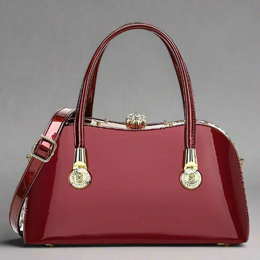 Luxury Red Patent Leather Designer Handbag with Diamond Gemstone Clasp and Rhinestone Detailing, featuring a push lock closure, detachable strap, and center zip compartment.