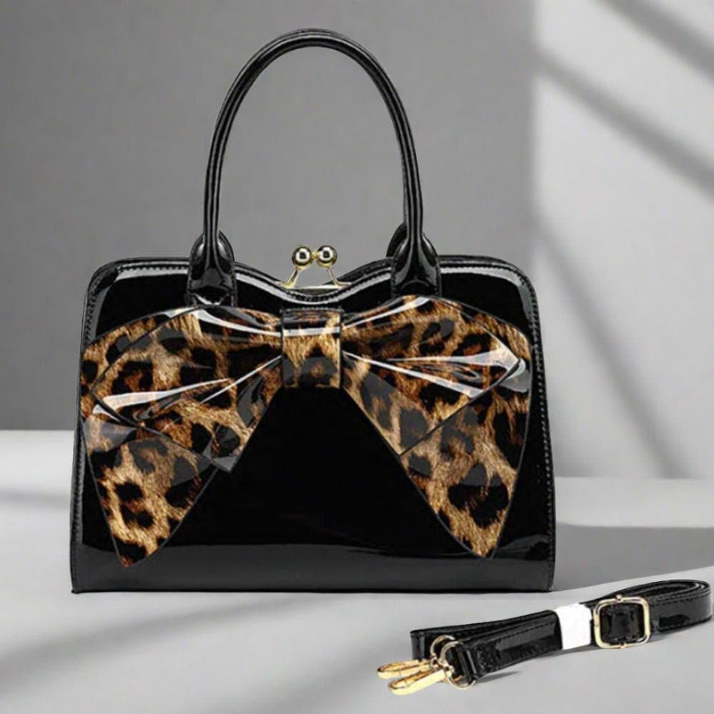 Black patent leather handbag with leopard print bow.